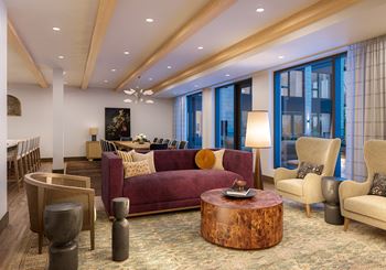 a large living room with a purple couch and chairs at Lilia, Minnesota, 55118